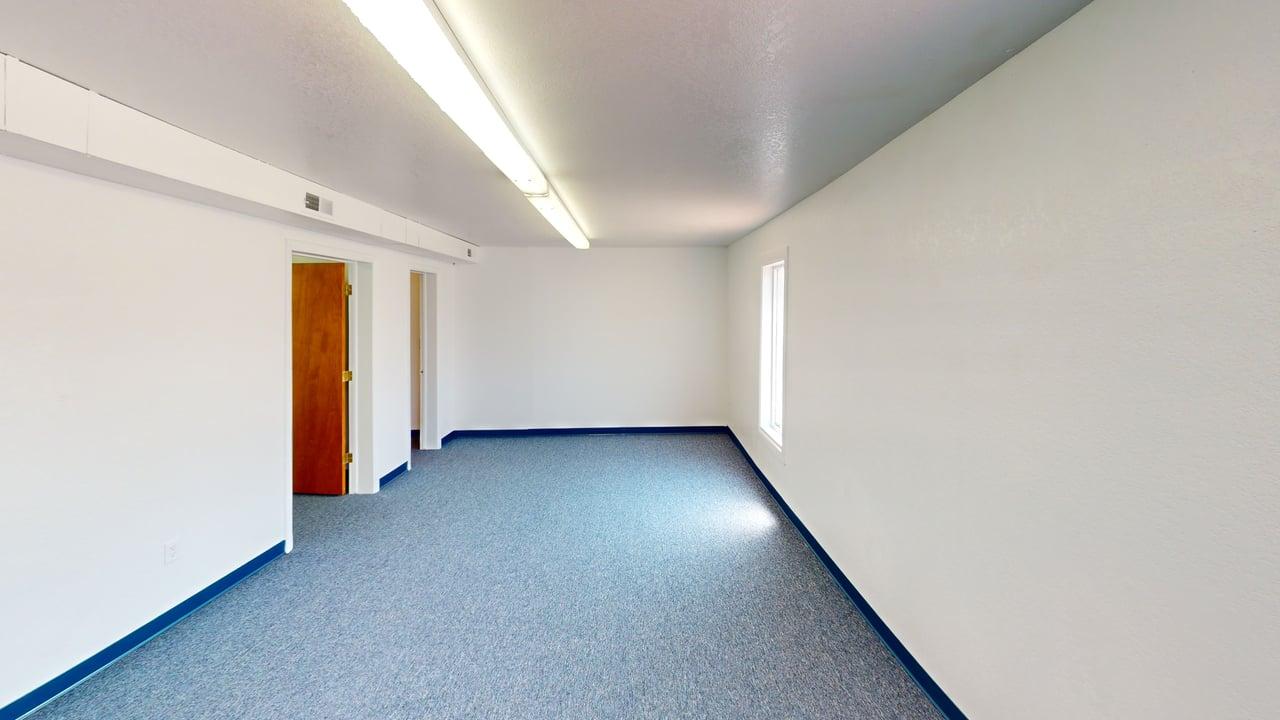 Private office room with window and doorway to adjoining rooms